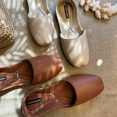 “Close-up of Cream Nawabi Khussa shoes highlighting cream leather texture and subtle ethnic detailing”