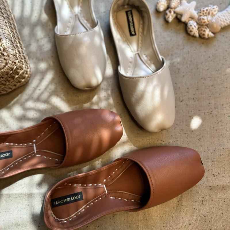 “Close-up of Cream Nawabi Khussa shoes highlighting cream leather texture and subtle ethnic detailing”