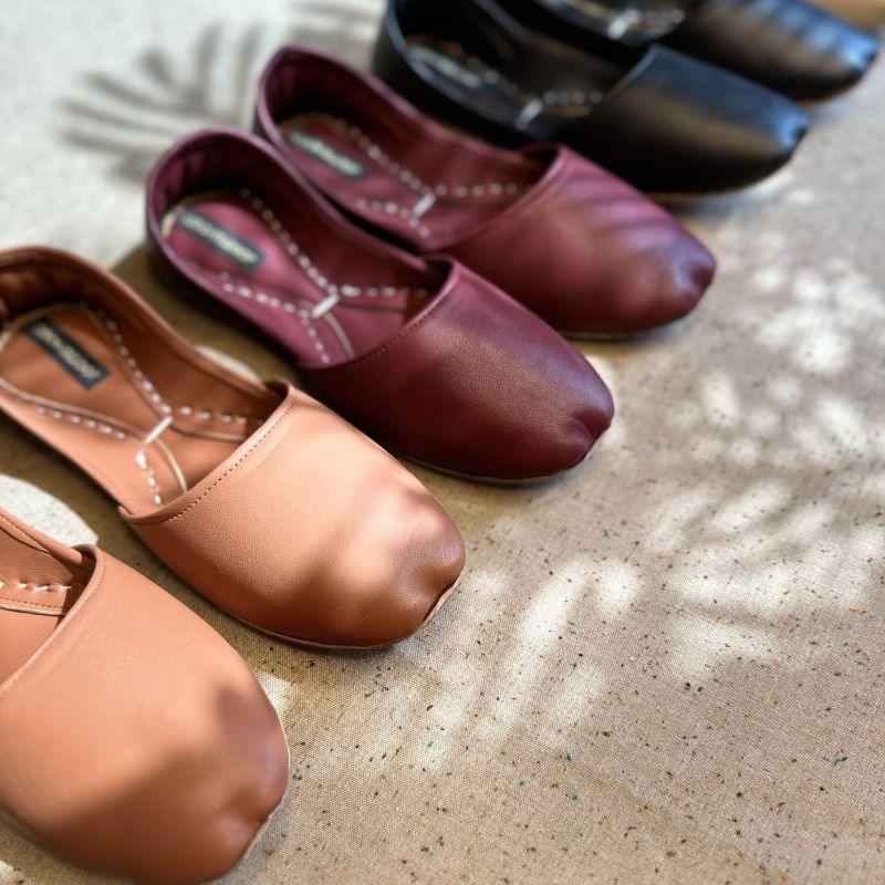 “Close-up of Black Nawabi Khussa shoes highlighting leather texture and subtle ethnic details”